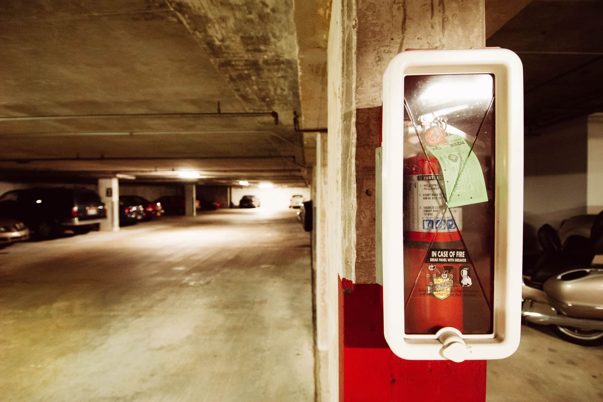 Illustrative photo of a large red fire extinguisher standing on a garage floor