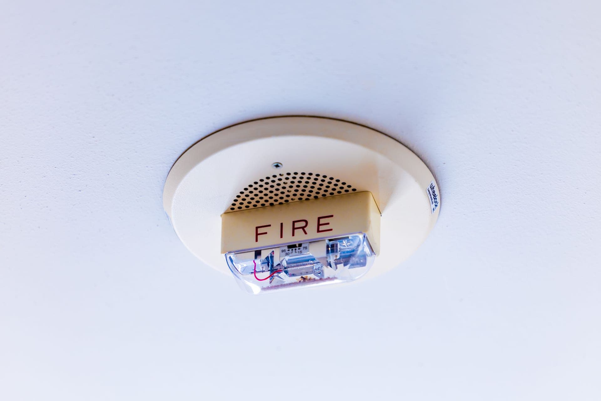 Illustrative photo of a hardwired combination smoke and carbon monoxide alarm on a ceiling