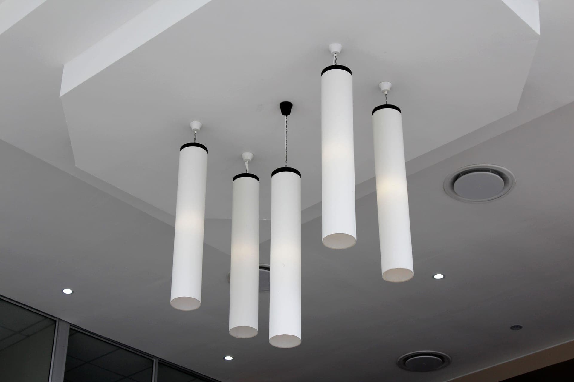 Illustrative photo of ceiling-mounted alarms in adjoining rooms of a two-story home