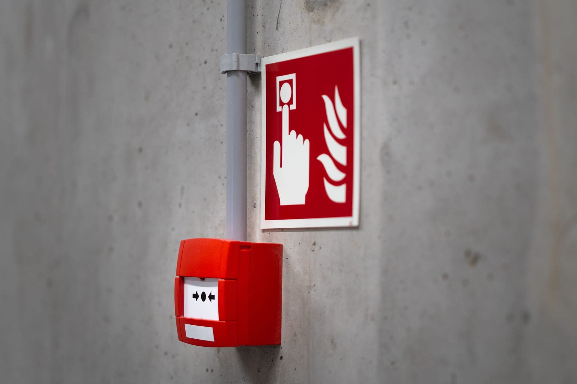 Close view of a ceiling-mounted alarm against a plain ceiling