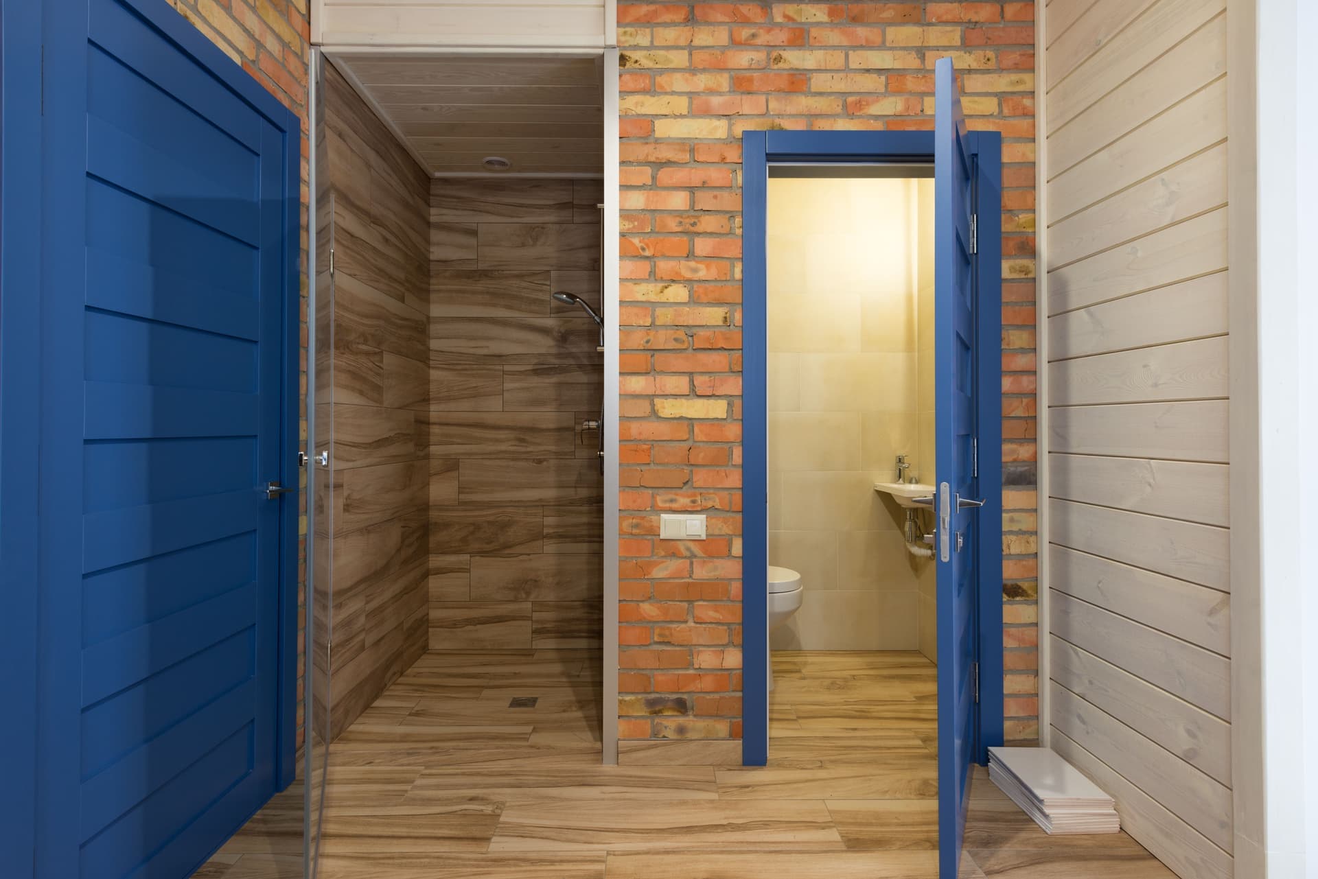 Hallway outside a bathroom door with a ceiling alarm nearby