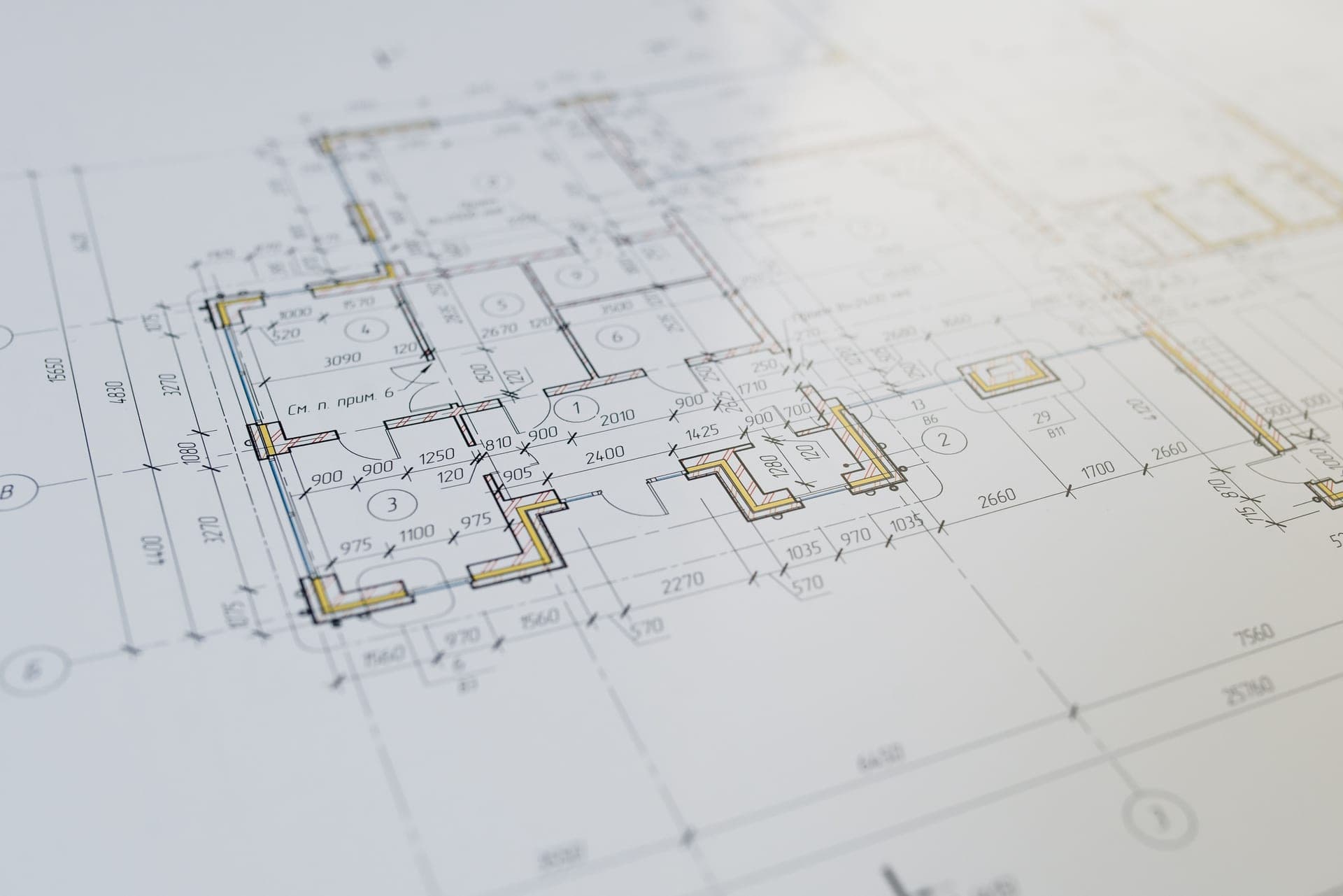 Architectural floor plan drawing on a desk