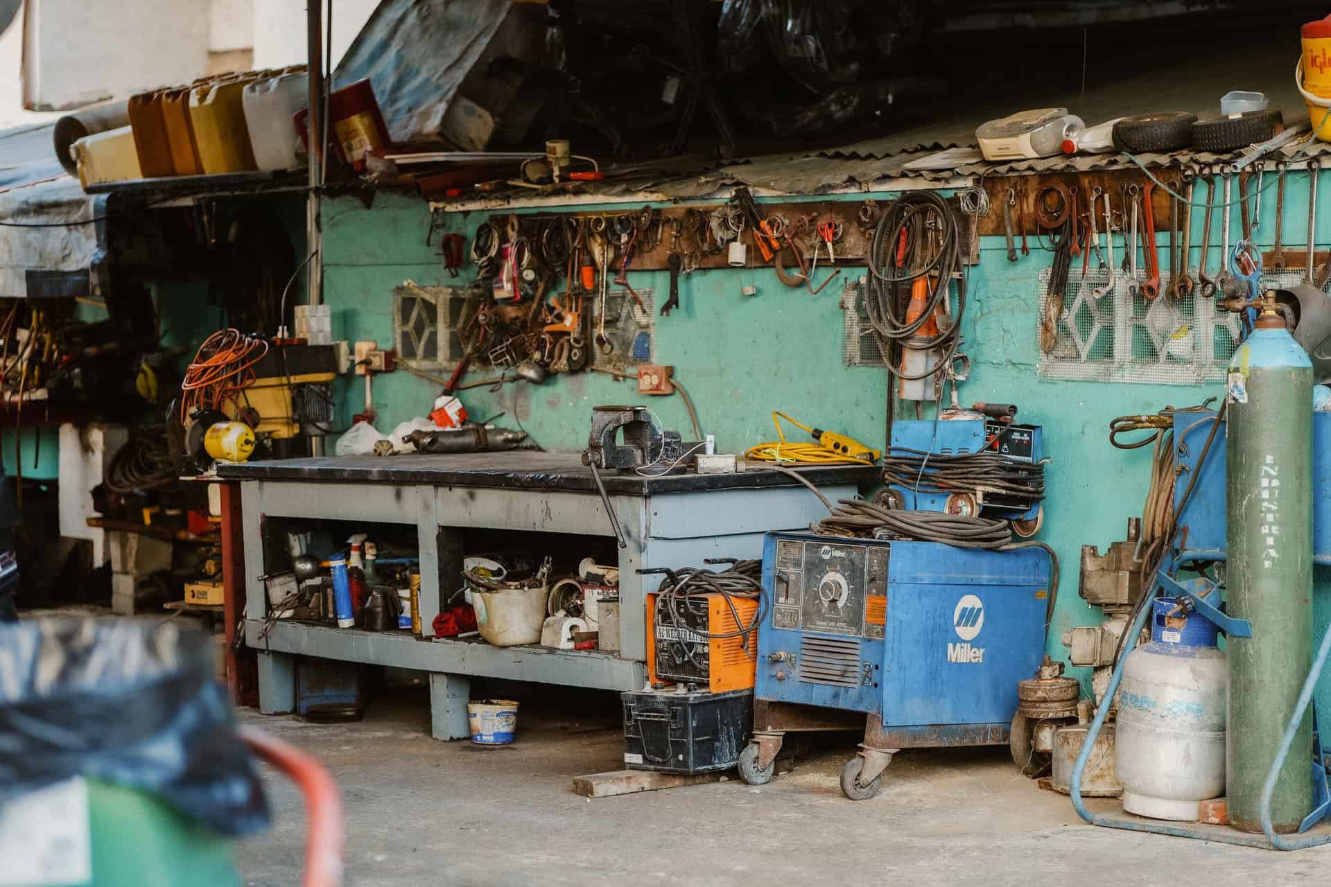 Garage workbench wall with tools and equipment mounted