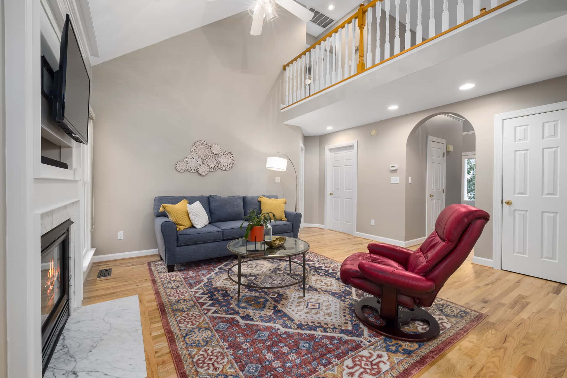 Living room with a high vaulted ceiling and exposed structure